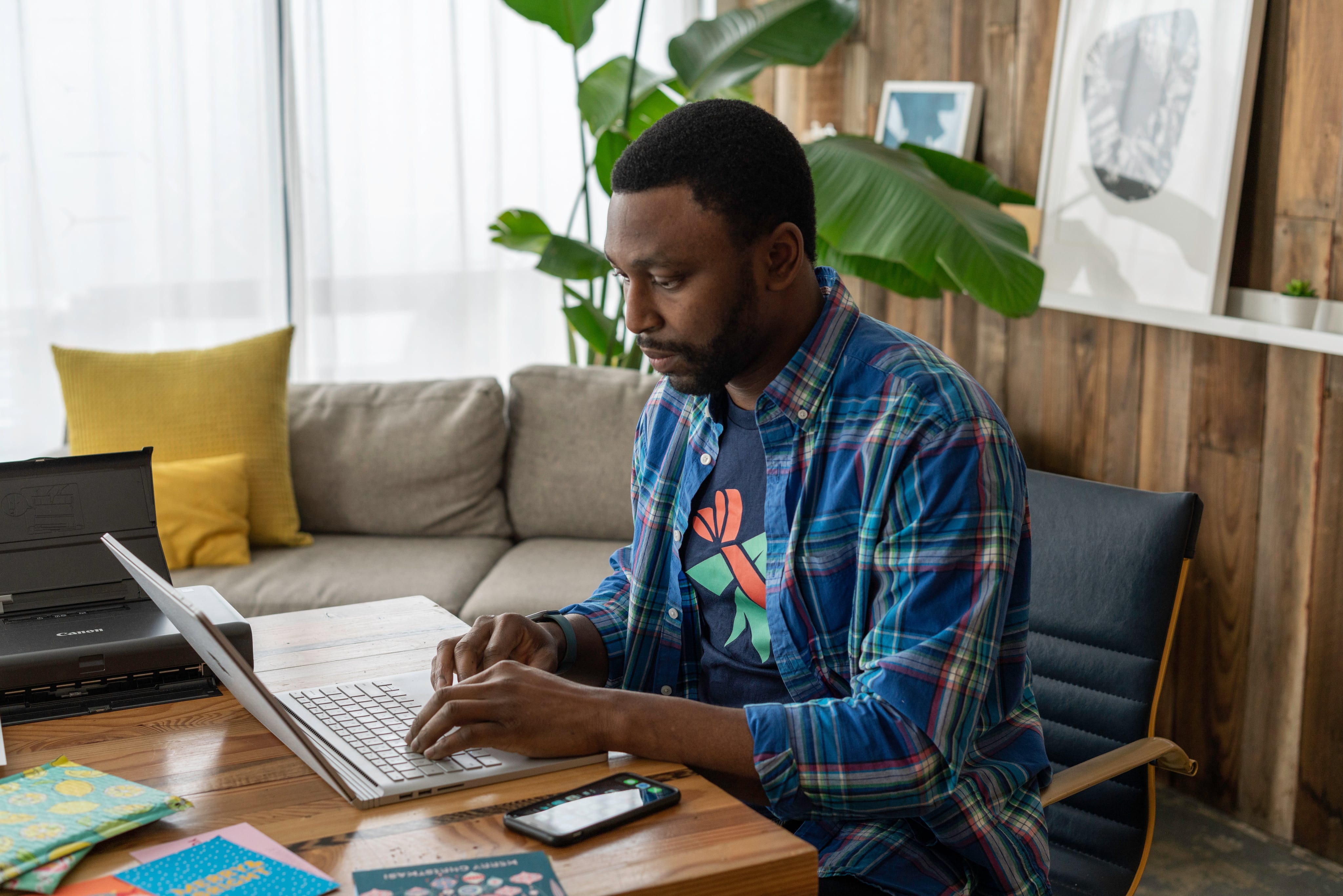 Man sat at desk on laptop